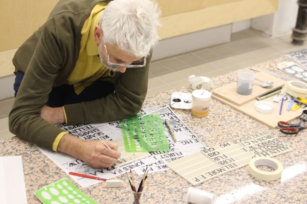 Mike Hurley working on lettering for memorial.