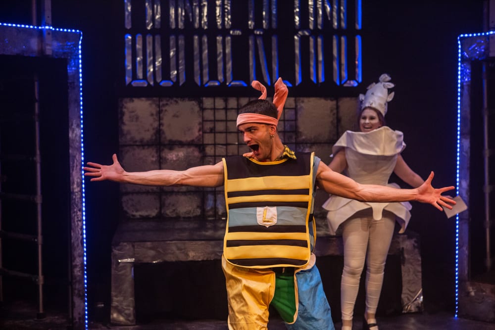 Acting performance on stage, man standing with arms wide open