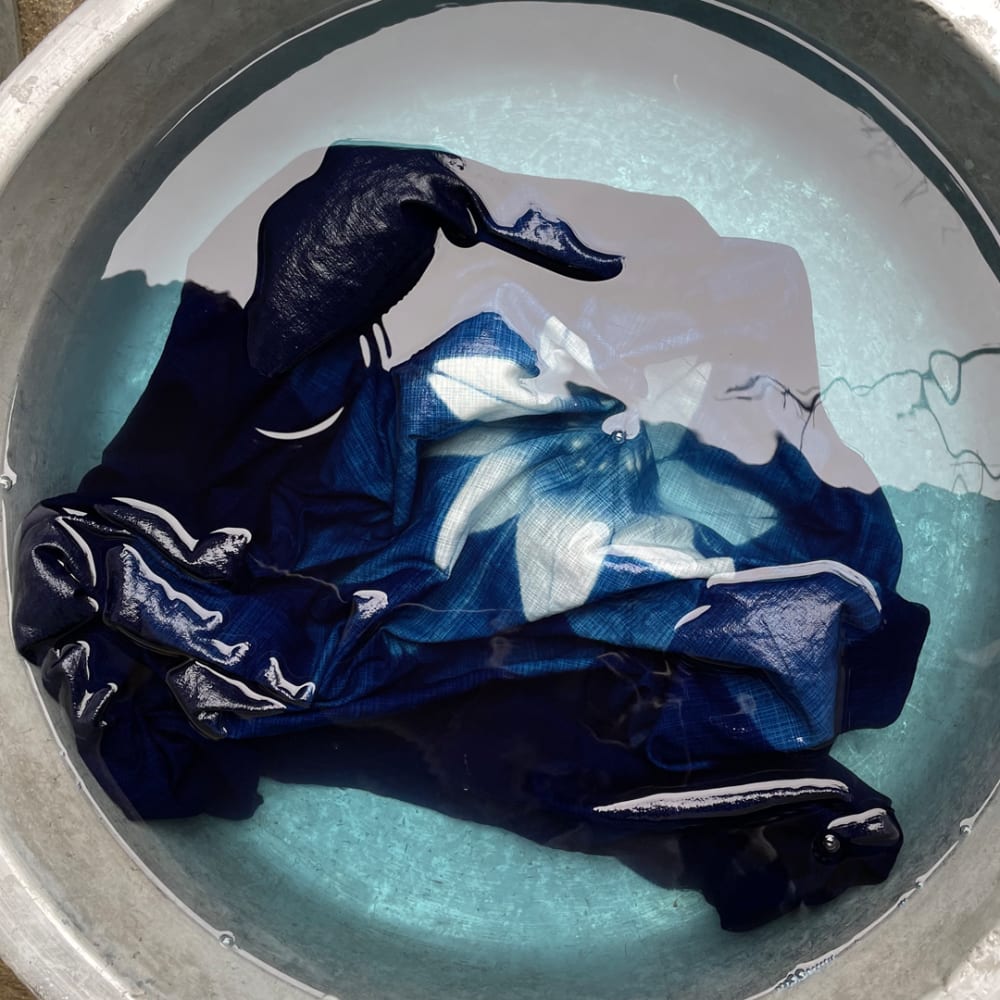 Image of cloth being washed after dyeing with the indigo
