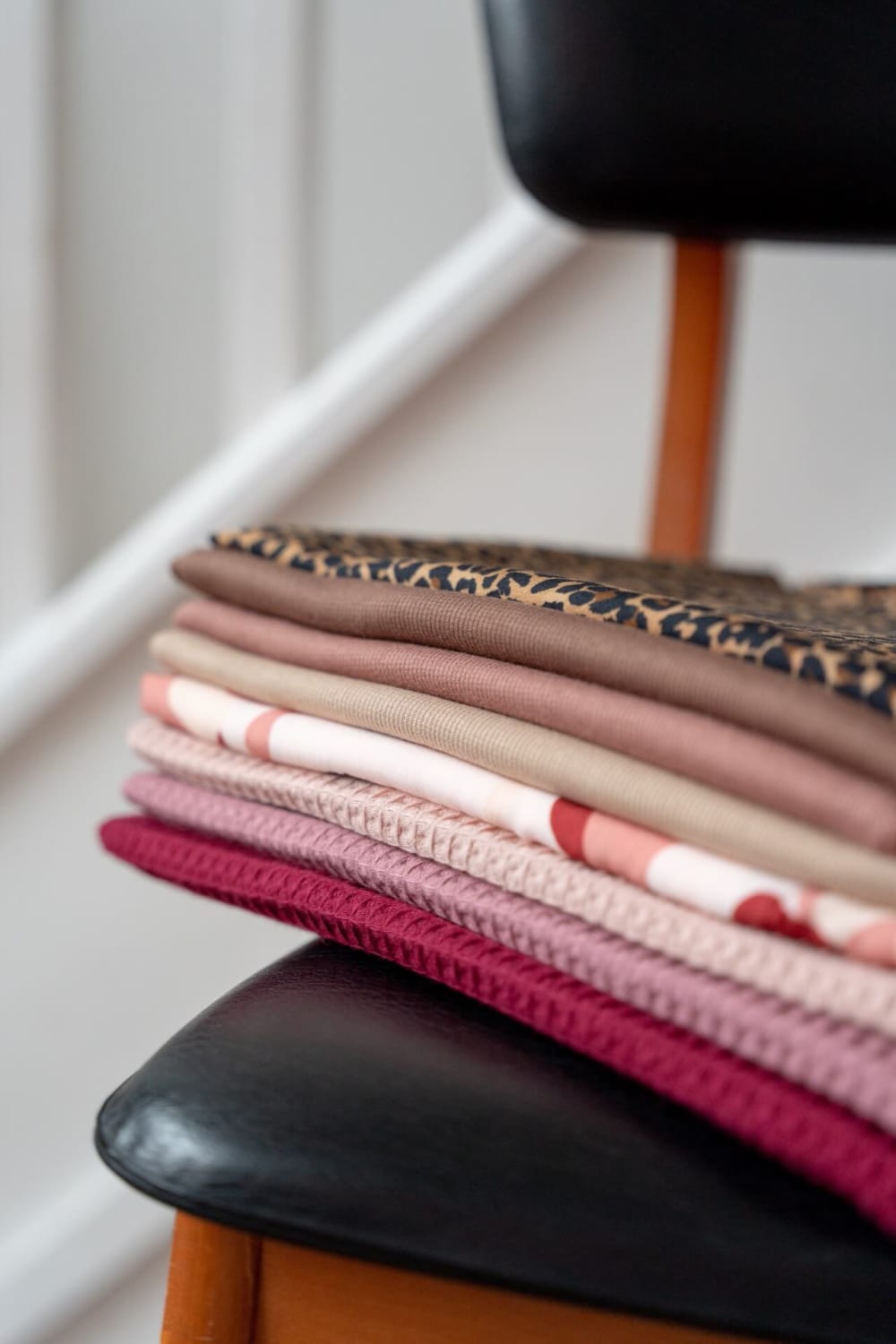 Pieces of material neatly folded on a chair