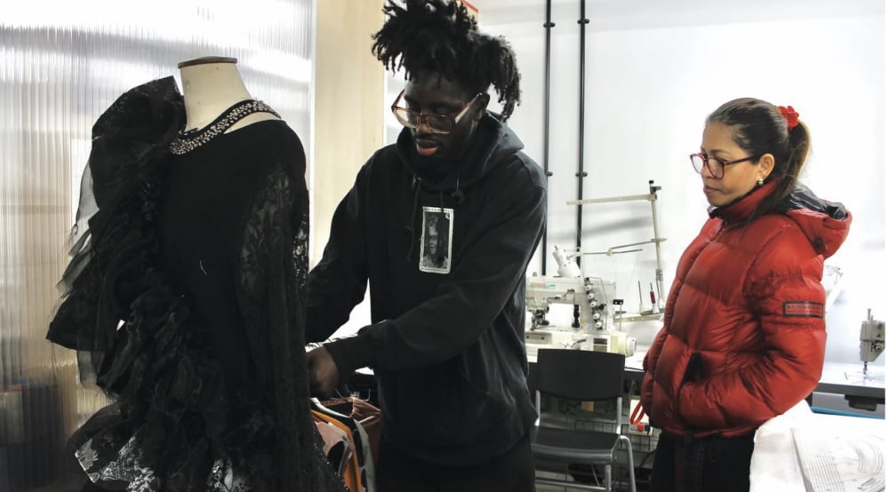 A student learning how to drape onto a mannequin