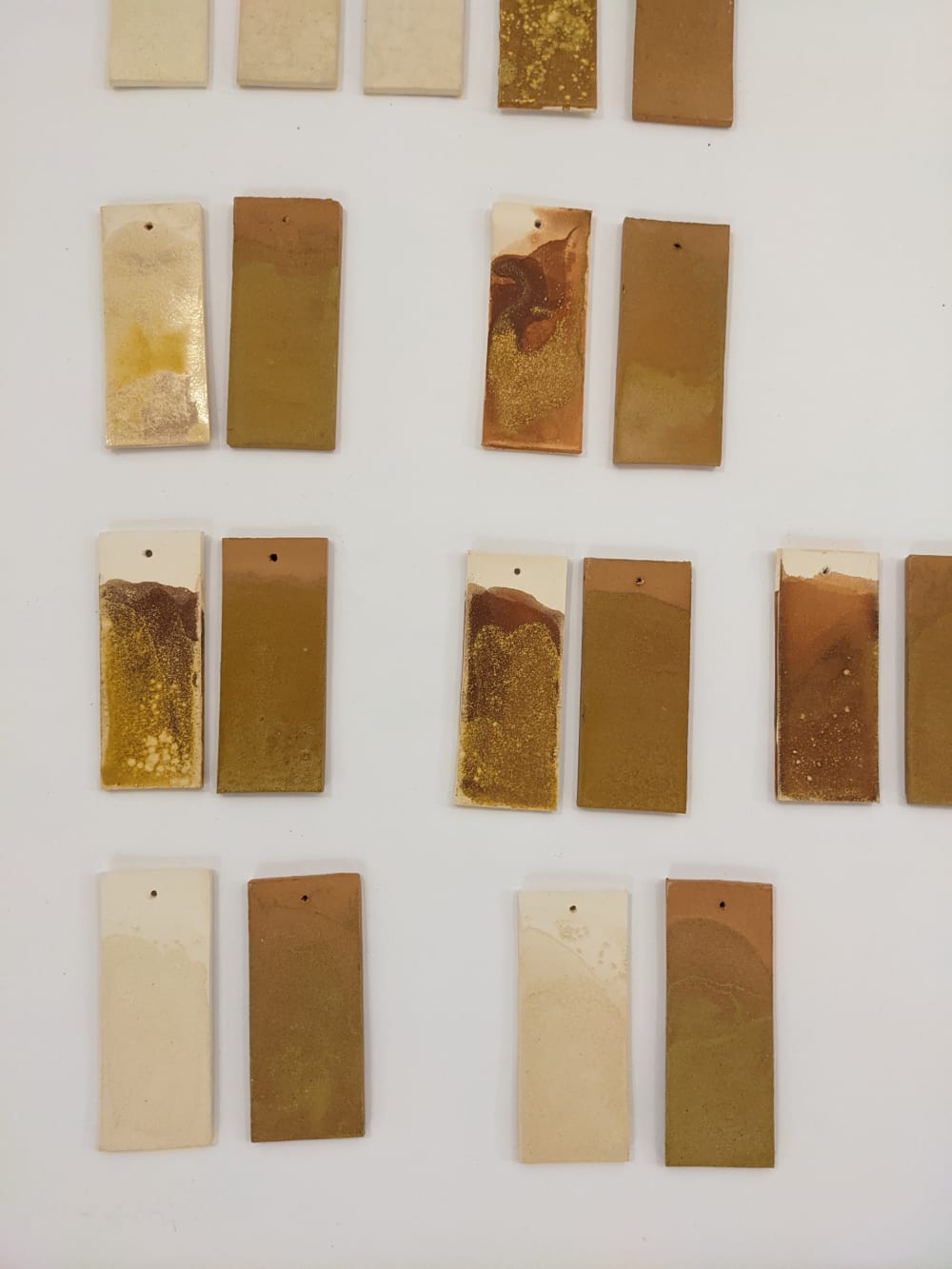 painted rectangles of bronze and gold on a wall