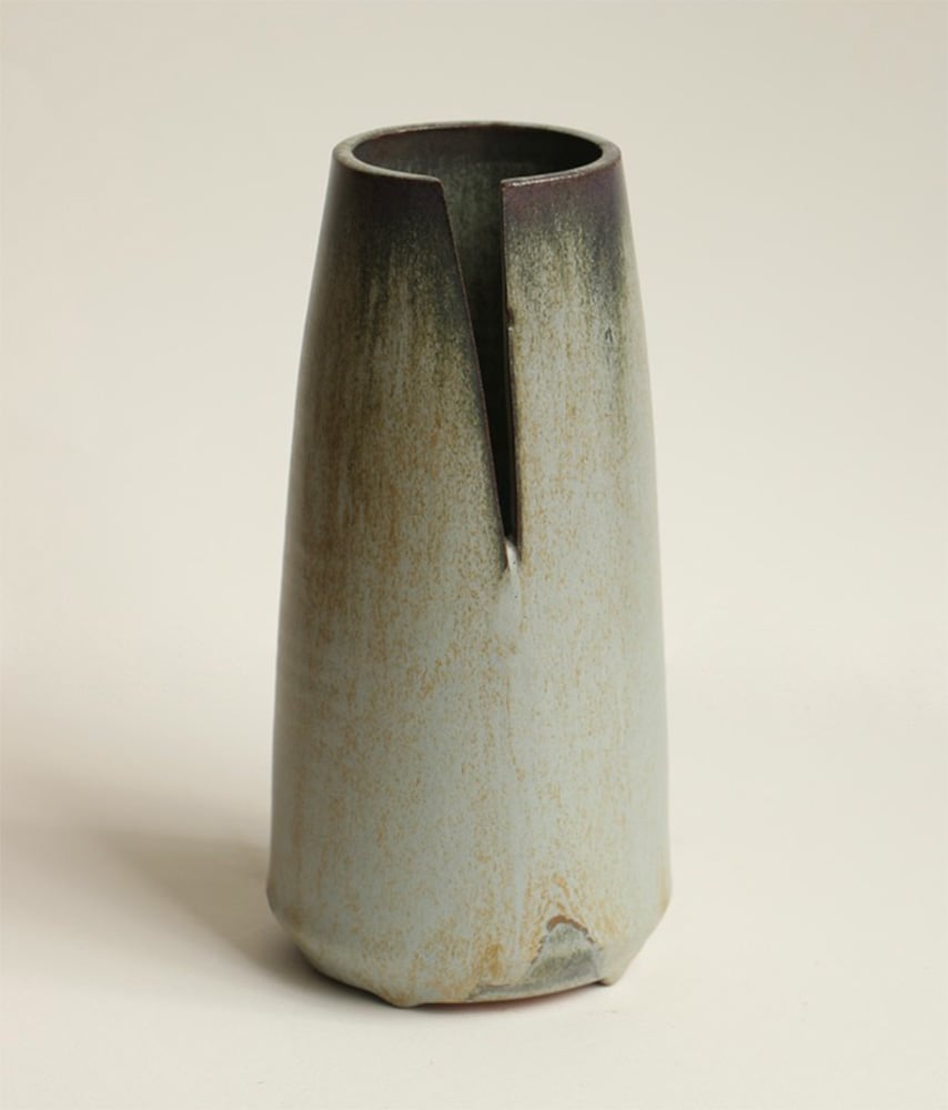 A clay pot with a crack in it