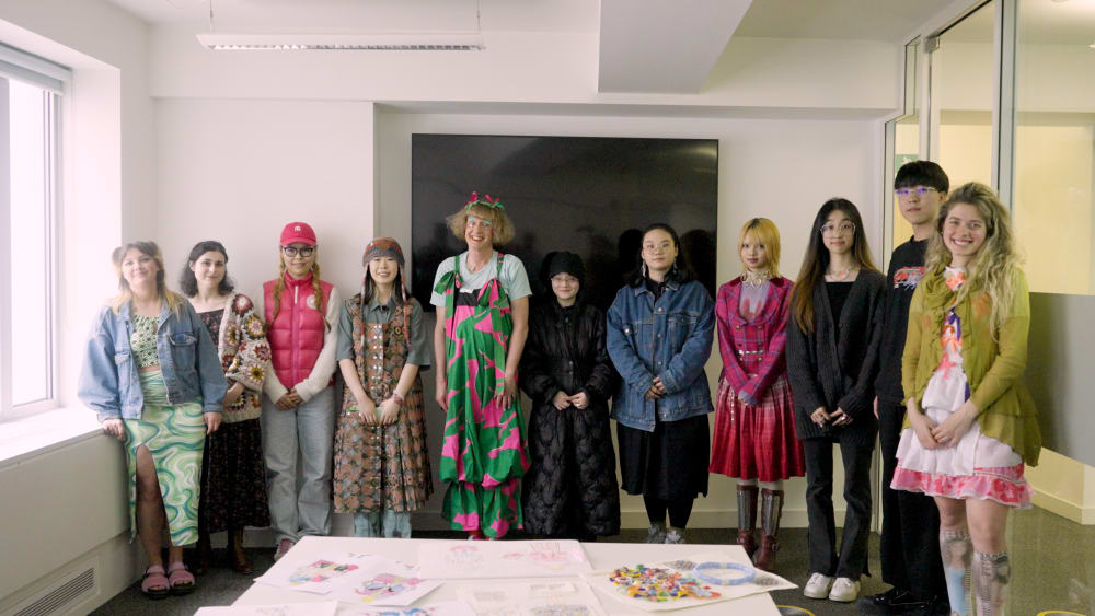 Photo of Grayson Perry standing in a room with students