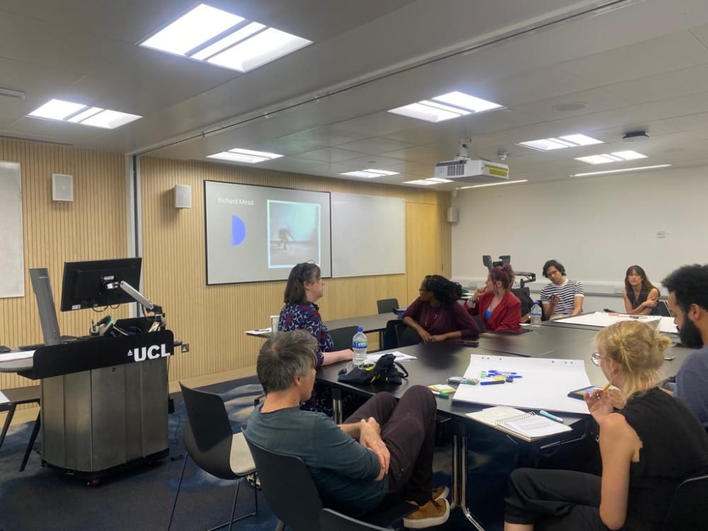 a group of students sat around a table talking