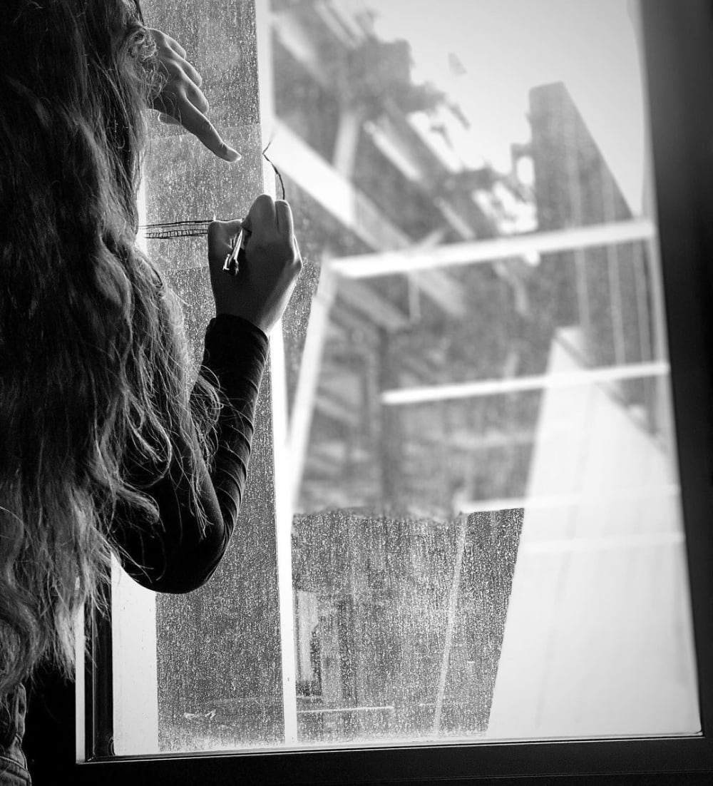 Person drawing on a window. 