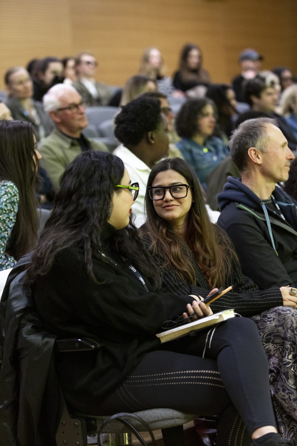 People sat in a lecture theatre chatting