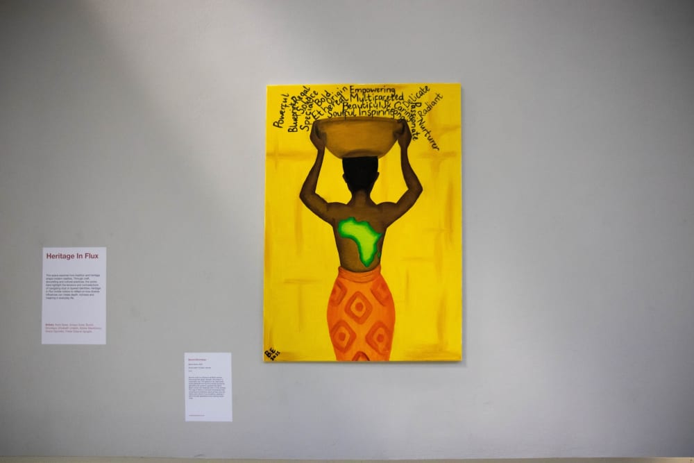 Image of artwork, person holding object on head. 