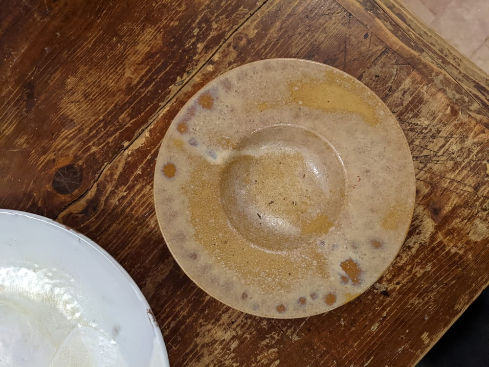 a clay bowl on a wooden table
