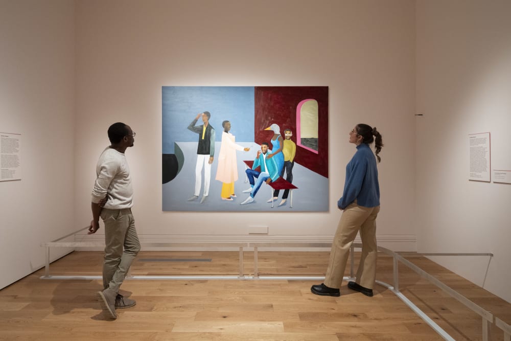 2 visitors looking at work by Lubaina Himid on display at the National Portrait Gallery