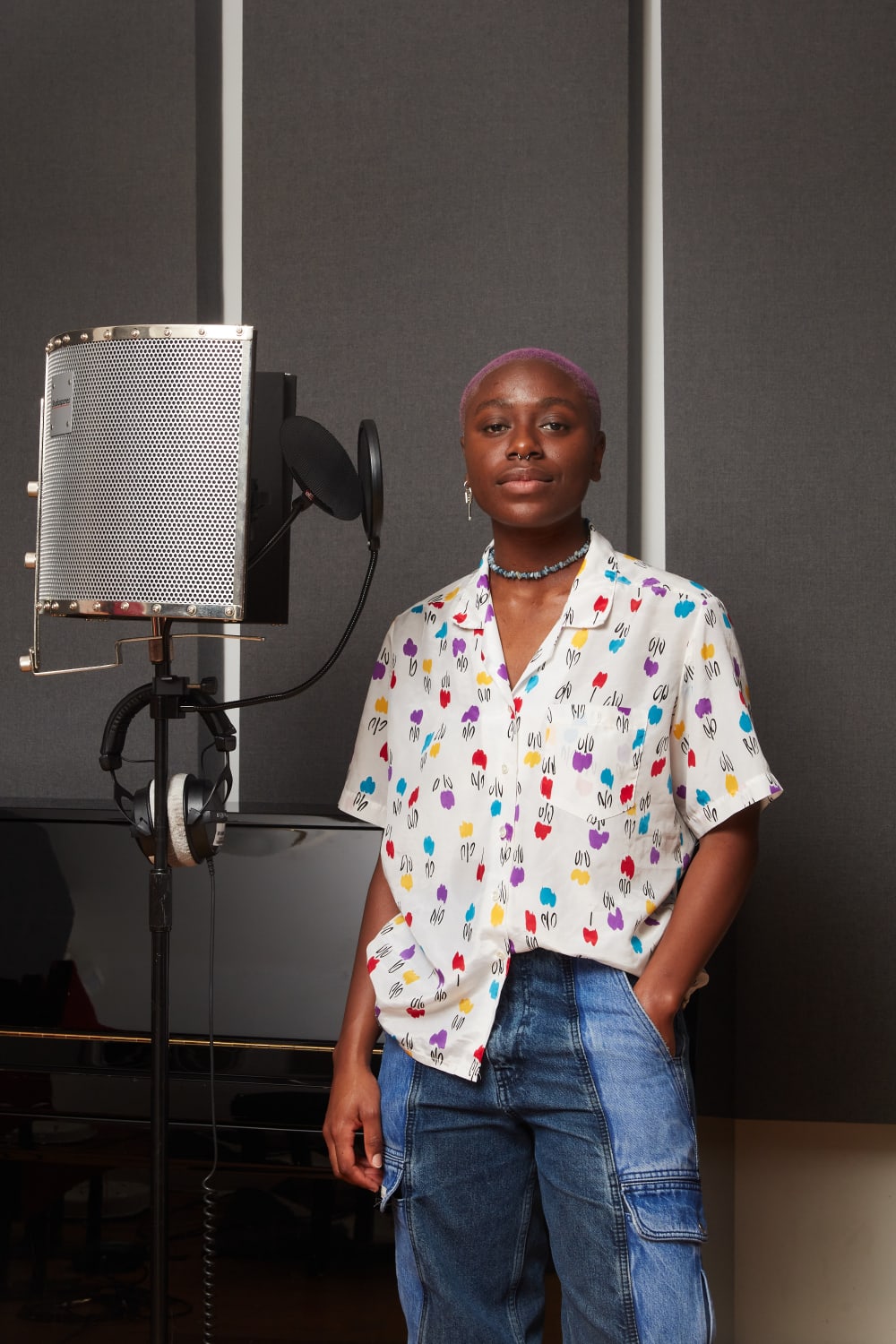 Photograph of Kobi Essah Ayensuo  wearing jeans and a colourful shirt