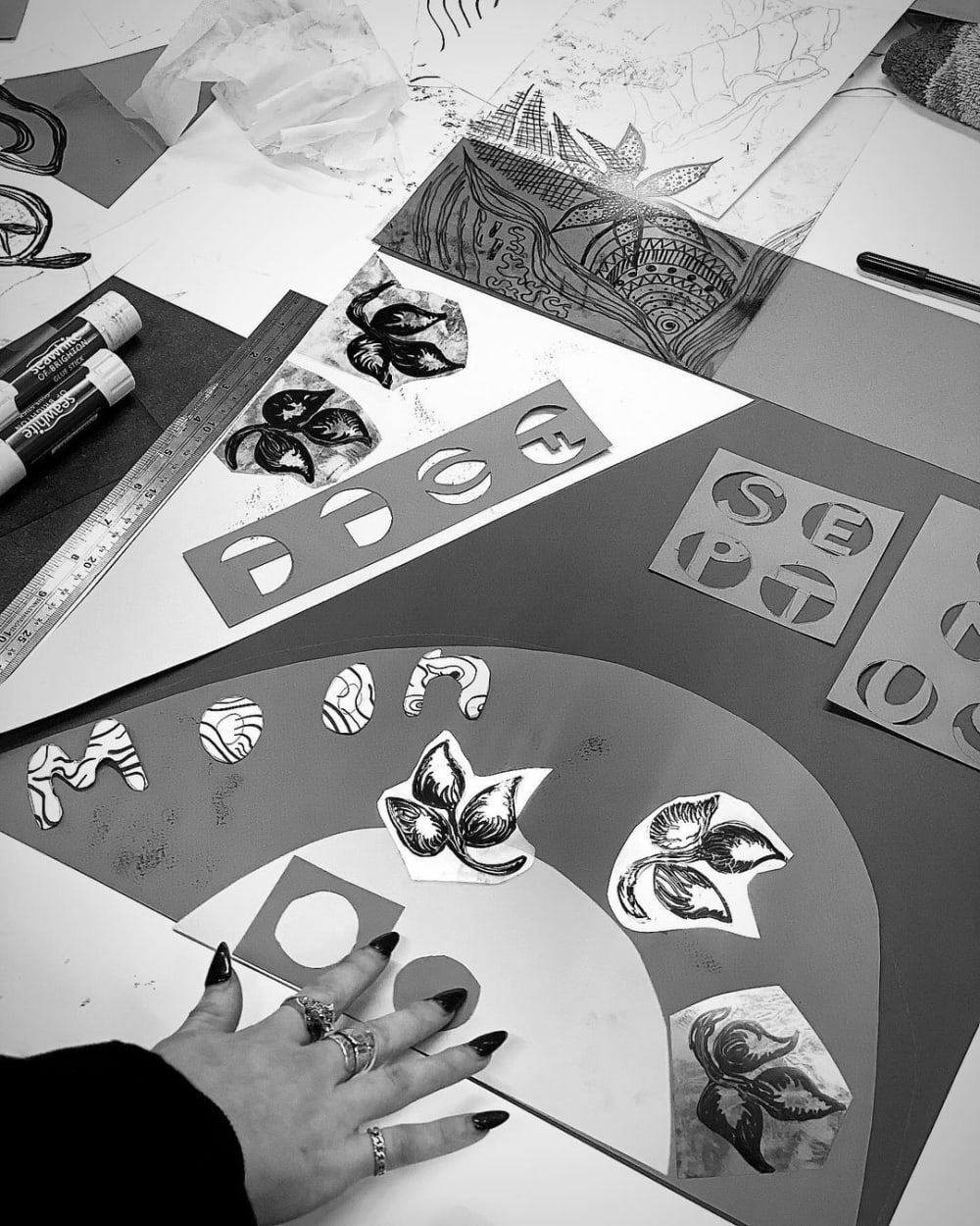 Drawings on a table, with 'moon' spelt out in patterned letters.