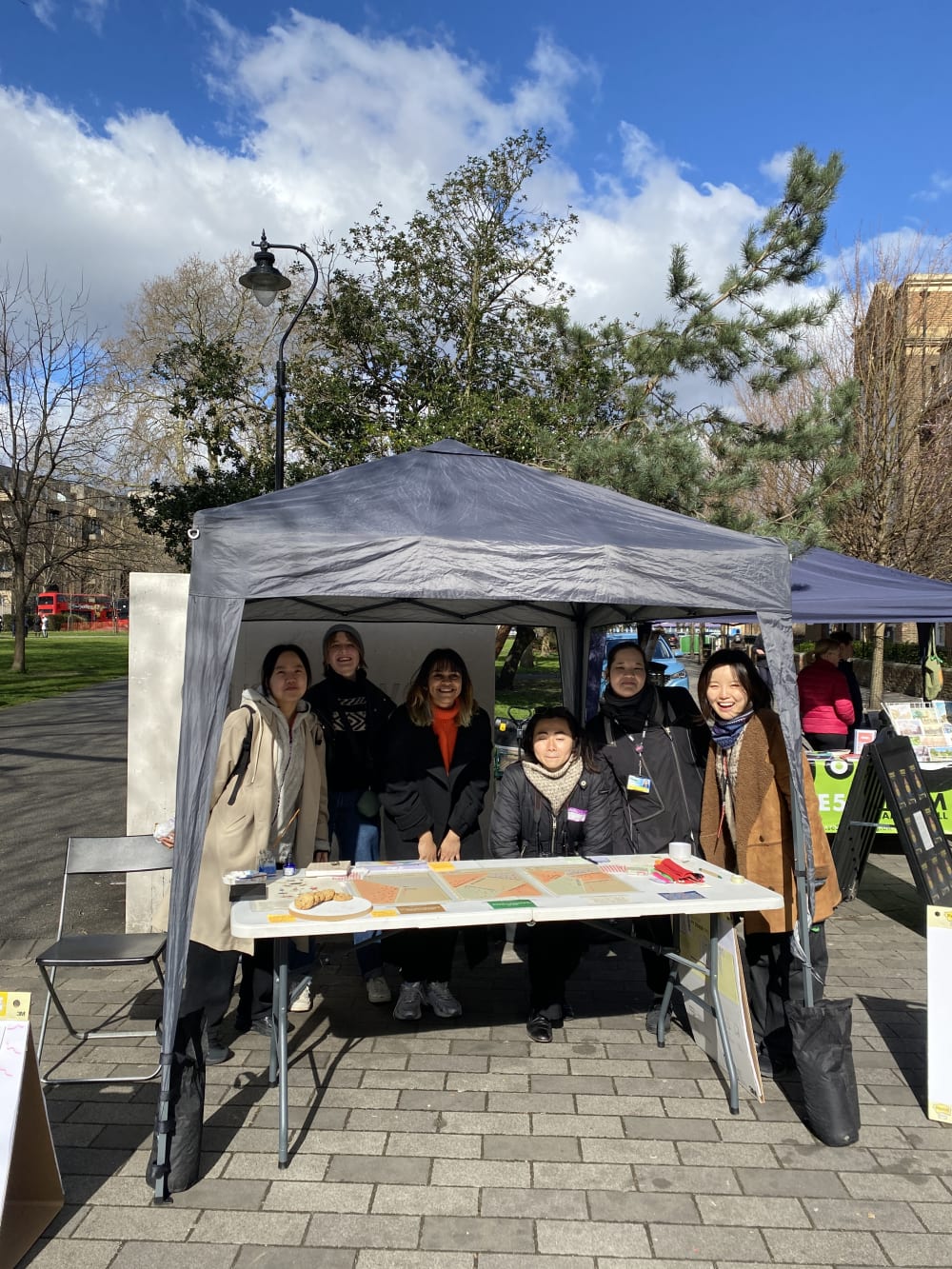Student standing behind a farmer's market stand