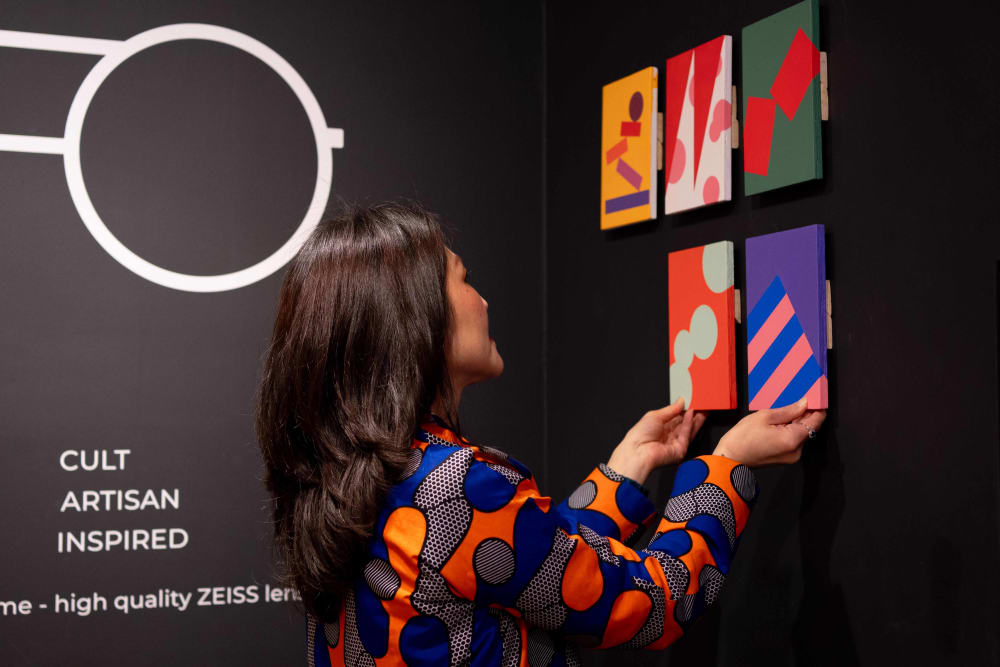 June hanging her artworks on the wall