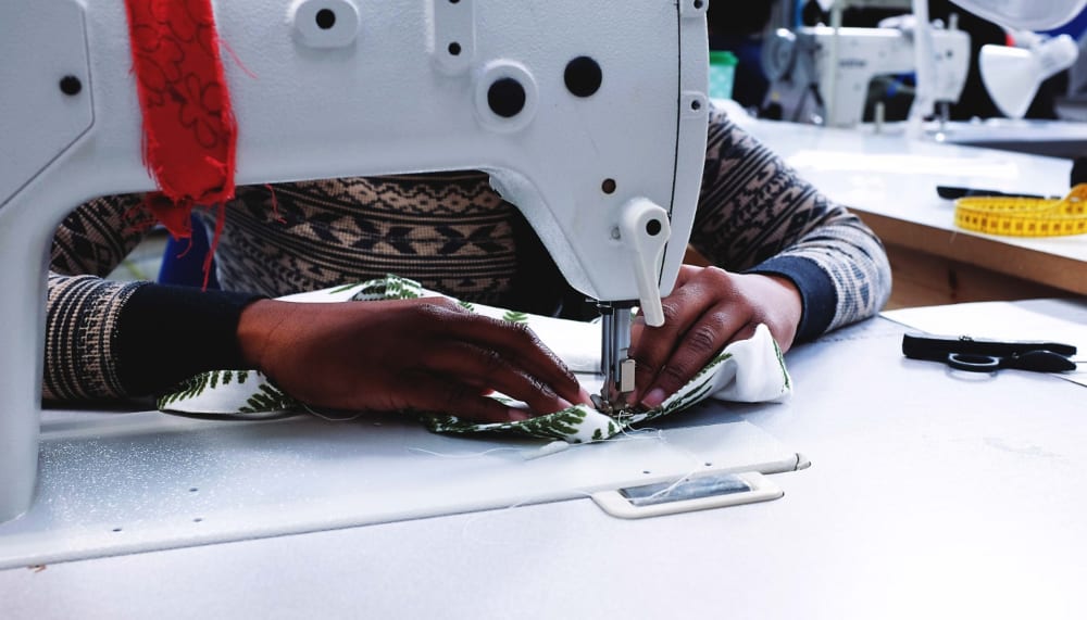 Making for Change participant using a sewing machine