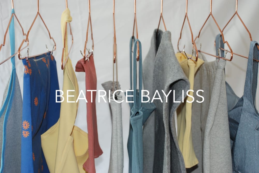 Clothes hanging on copper hangers with BEATRICE BAYLISS