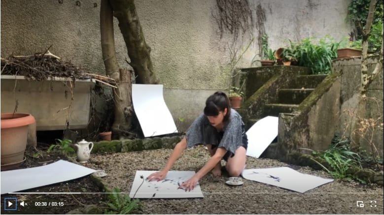 a woman on the ground handling paper