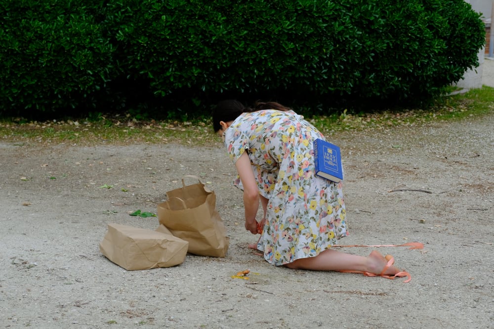 a girl kneeling on the ground