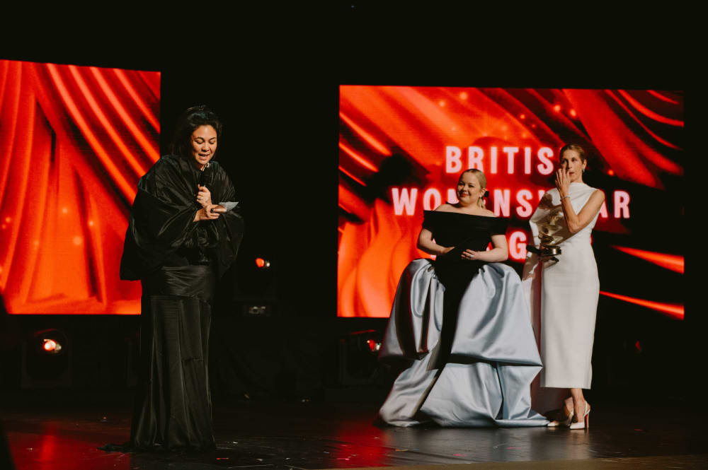 Simone Rocha receiving her award, with Kelly Rutherford and Nichola Coughlan standing to the side