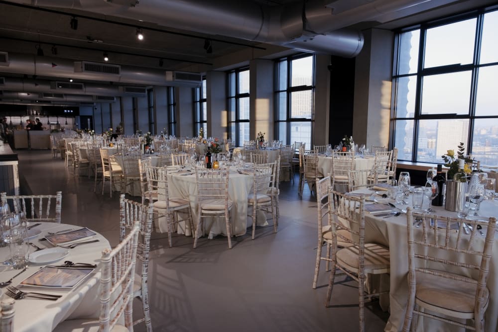 Canteen with tables and chairs arranged for a gala dinner.