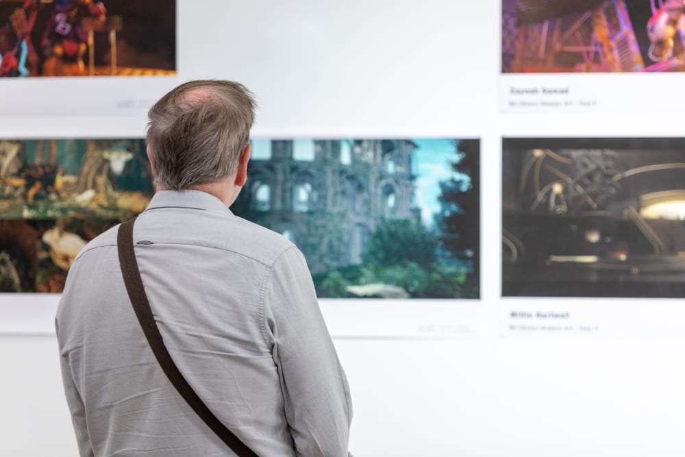 UAL students and alumni looking at the graduates' work