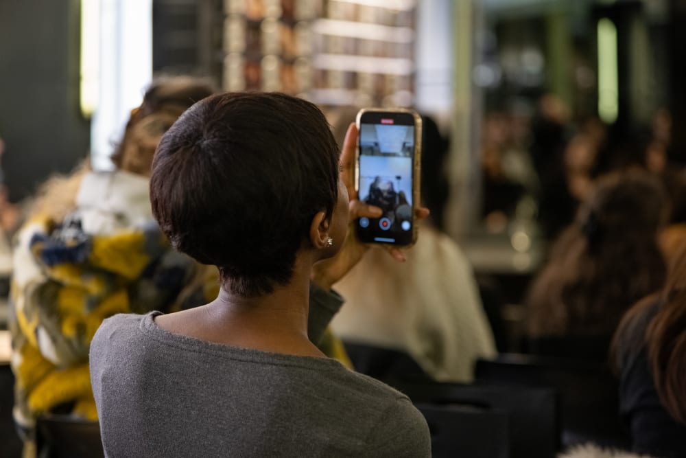 a person taking video of the makeup demonstration