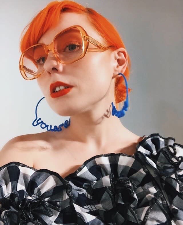 Woman wearing 'You&Me' hoop earrings