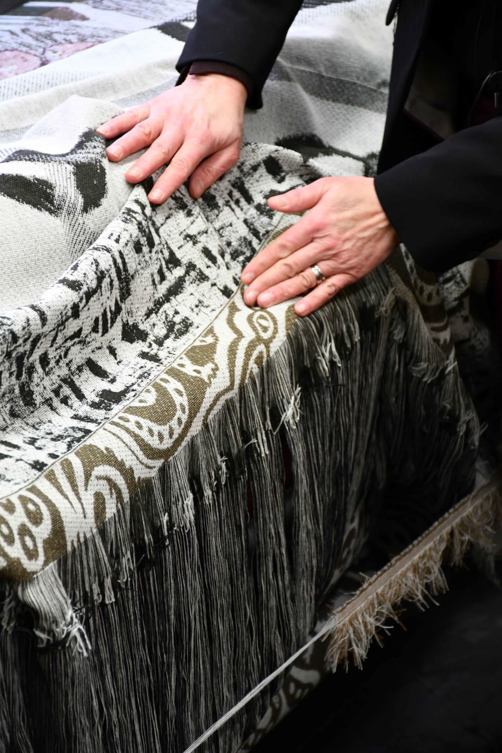 Person making woven fabric on machinery 