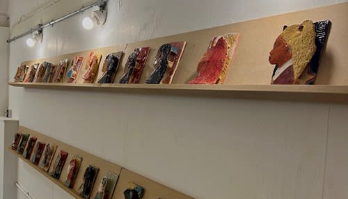 A wall of ceramic portraits.