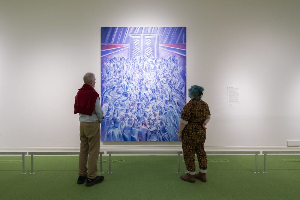 Visitors looking at work by Denzil Forrester on display at the National Portrait Gallery