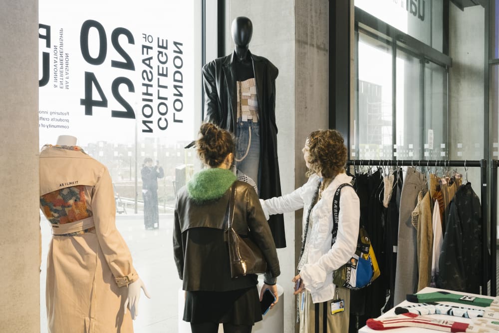 People looking through clothing rail