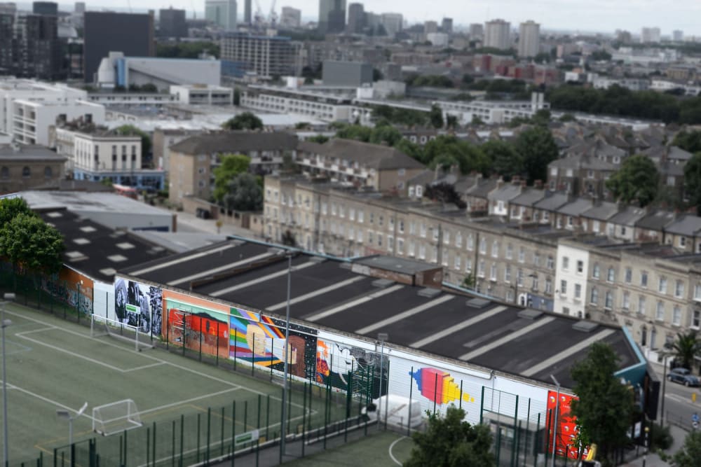 A view over a terrace of houses and a football pitch