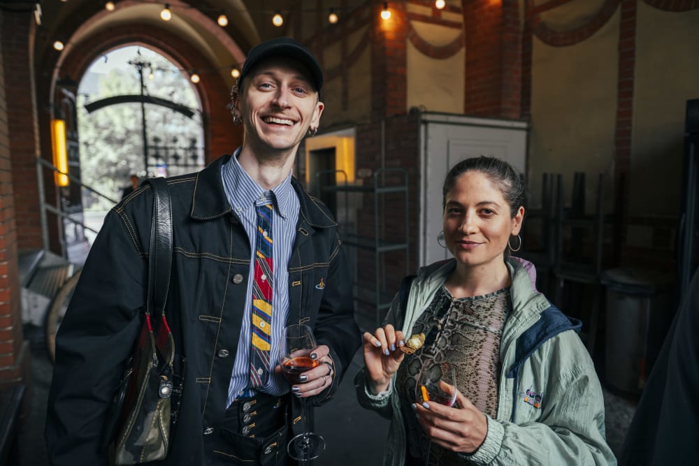 2 guests, smiling to camera