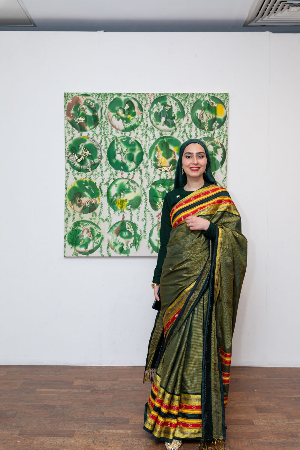 Samar standing and smiling to the camera