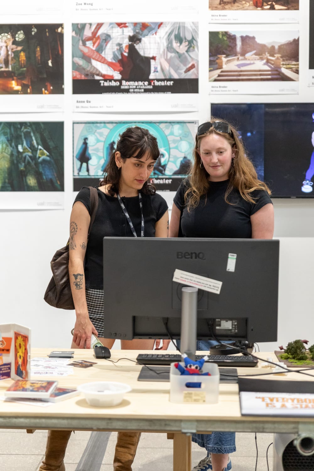 UAL students and alumni looking at the graduates' work