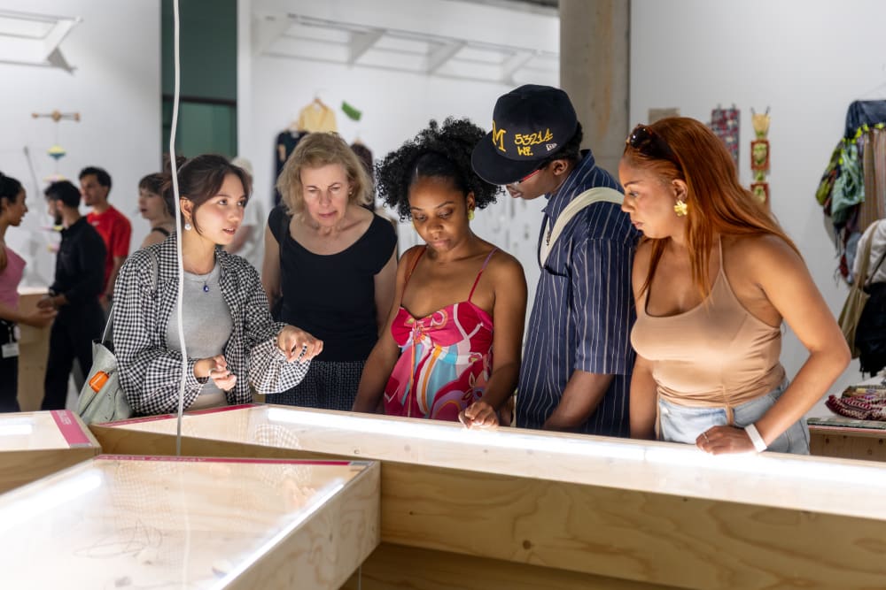 UAL students and alumni looking at the graduates' work