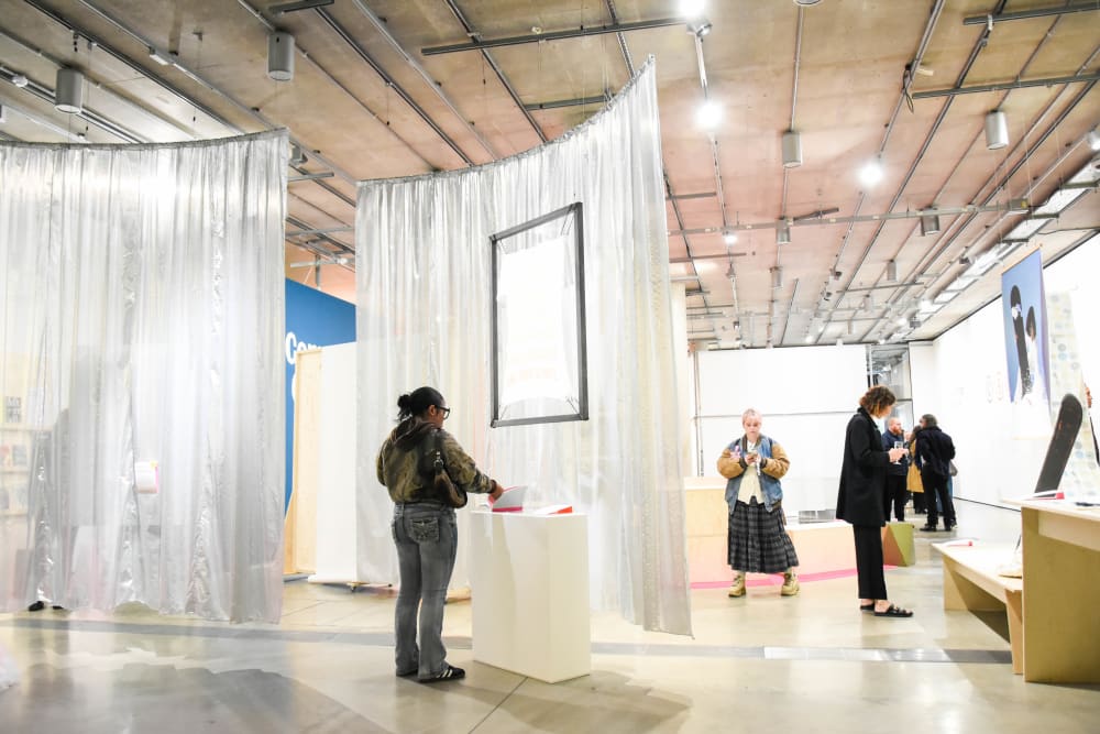 an image of a woman in an art gallery inspecting a piece of art