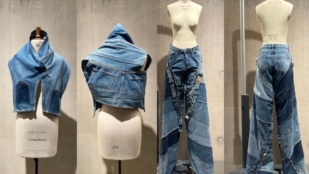 A series of mannequins display denim fashion pieces. On the left, a cropped denim jacket with dark patches. Next, a folded denim piece resembling a hooded cape. On the right, jeans with patchwork and belt details. The tone is artistic and innovative.