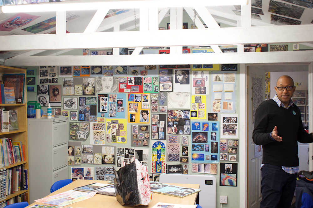 Course leader in room decorated by student artworks. 