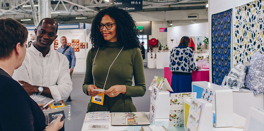 Photo of designer Michelle Njeri Small talking to buyers