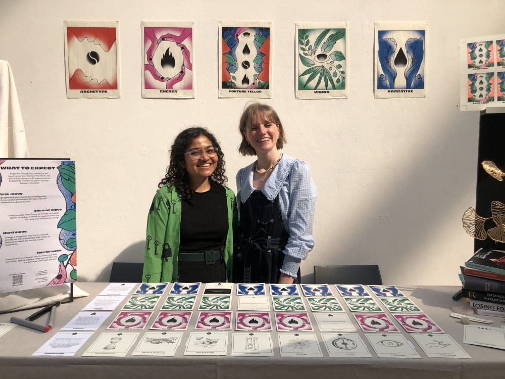 Fortune Tell-Us stand at CSM Street, with Purvisha Sutaria and Molly Simpson (MA Innovation Management students)