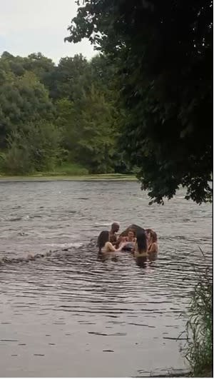 people swimming in a lake