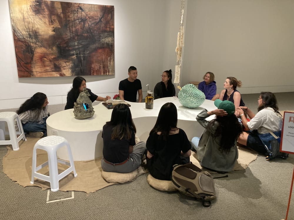Curators and students sat around the exhibition space