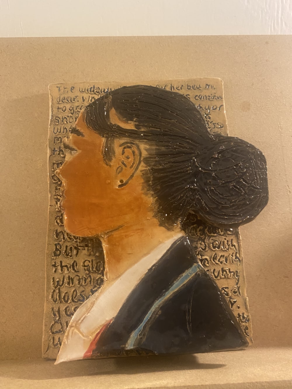 A portrait of a young woman's head with detailed hair.