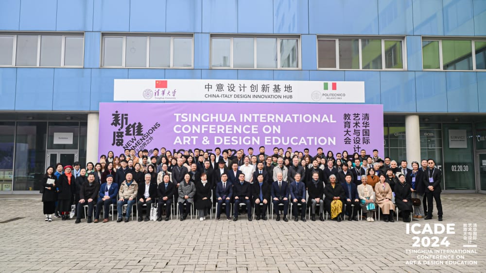 All significant attendees taking a group picture in front of building