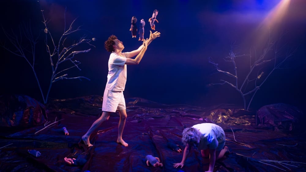 Two people dressed in white acting in a play