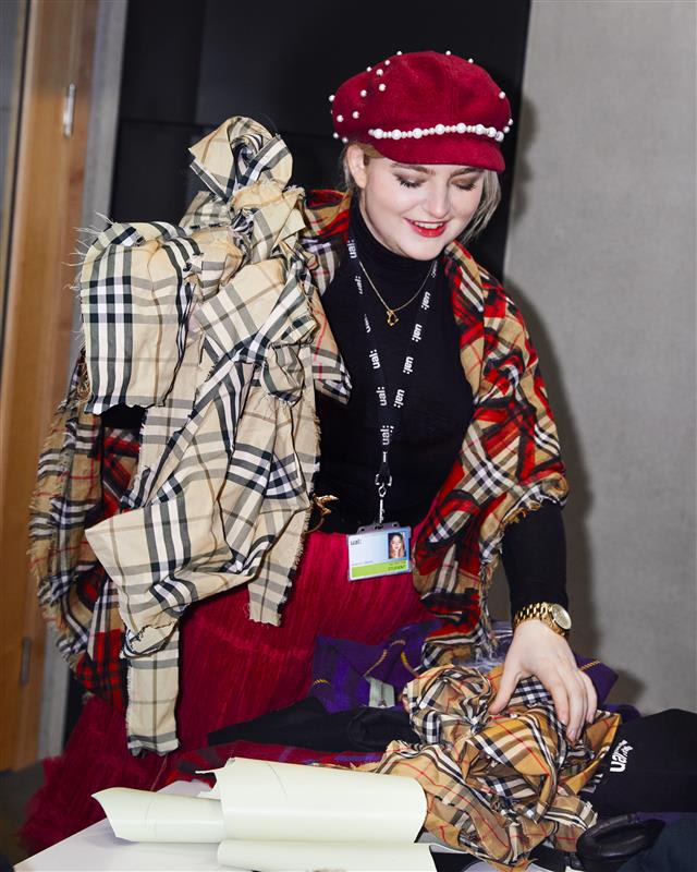 Person holding up fabric.