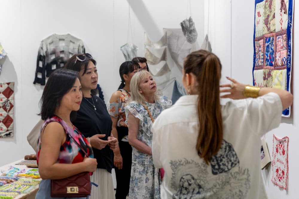 UAL students and alumni looking at the graduates' work