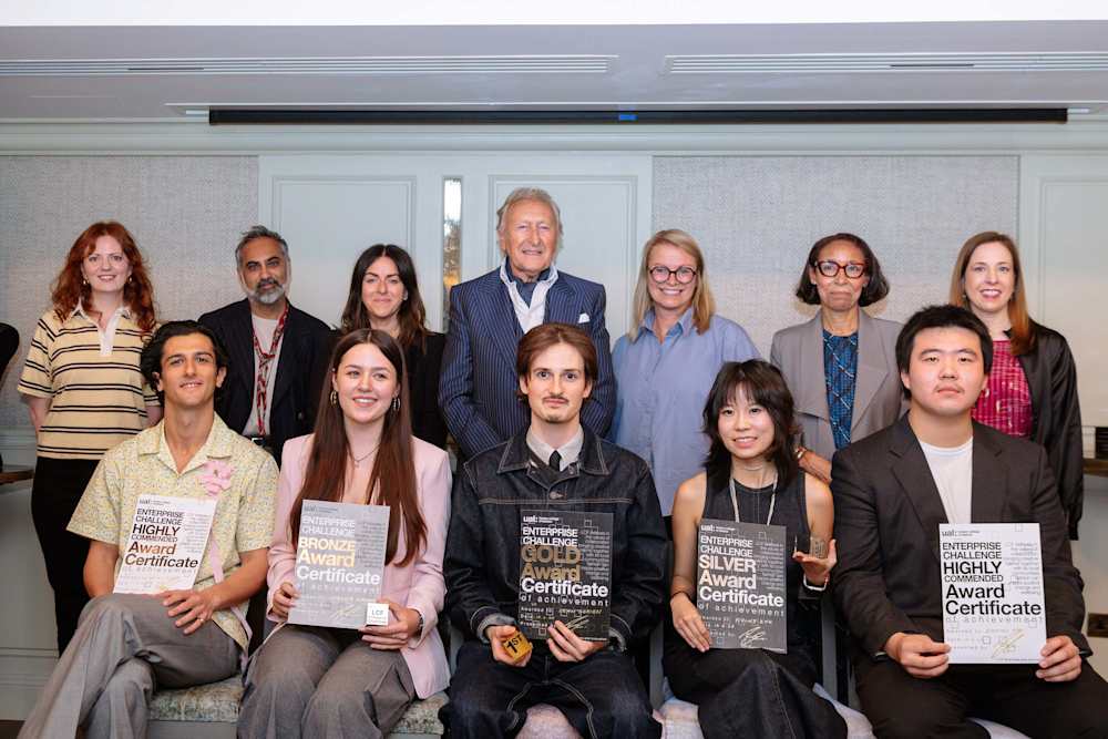 A group of people sitting and standing holding certificates.