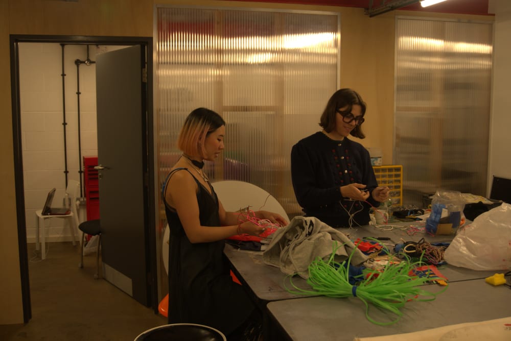 Two girls working in a studio.